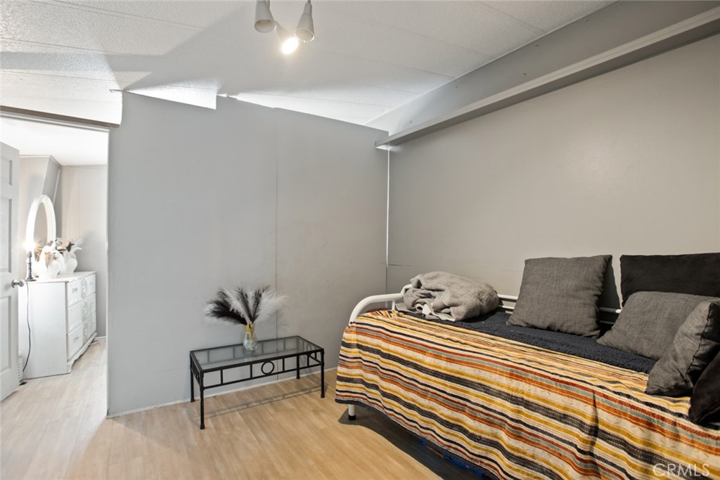 1414 West Central Avenue, Unit 10 Brea, CA 92821 - Photo 21 of 28 a bedroom with bed and wooden floor