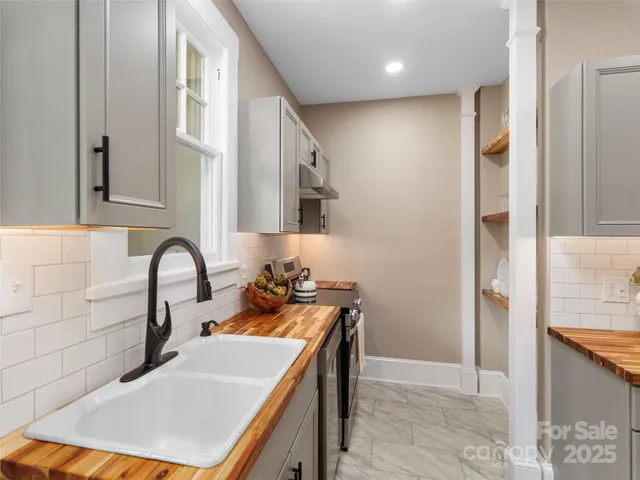 a kitchen with a sink a stove and refrigerator