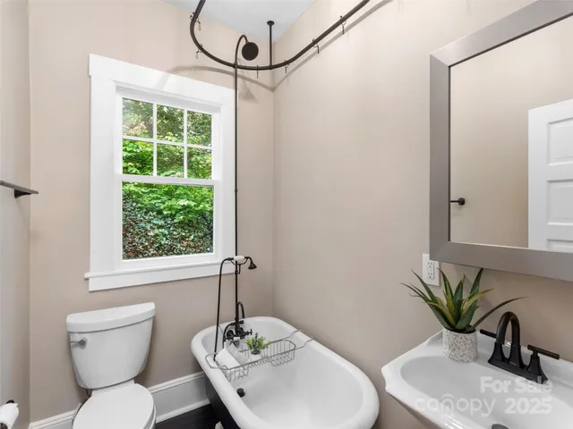 a bathroom with a toilet a sink and a window