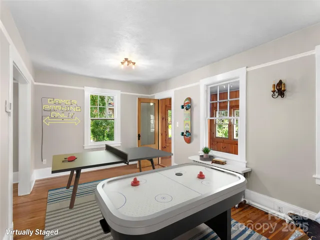 a room with furniture pool table and windows