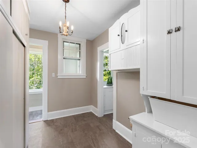 a spacious bedroom with a bed and a chandelier