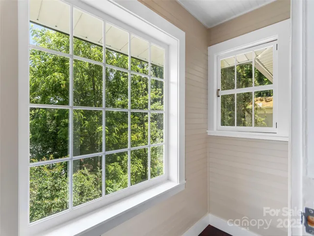 a view of a hallway with a chandelier fan