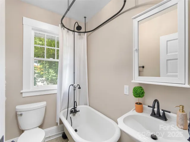 a view of empty room with window and wooden floor