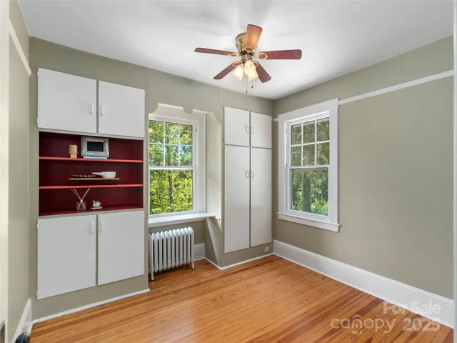 a bedroom with a bed dresser and a window
