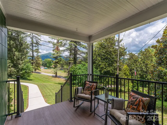a balcony with furniture and a swing