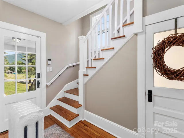 a view of entryway and hall with wooden floor