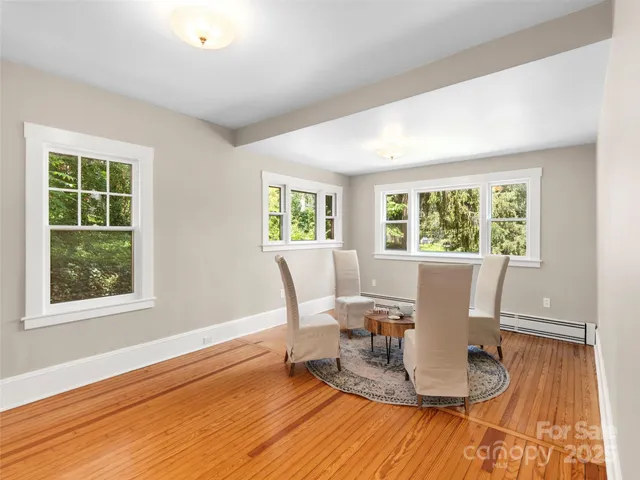 a view of a dining room with a table and chairs