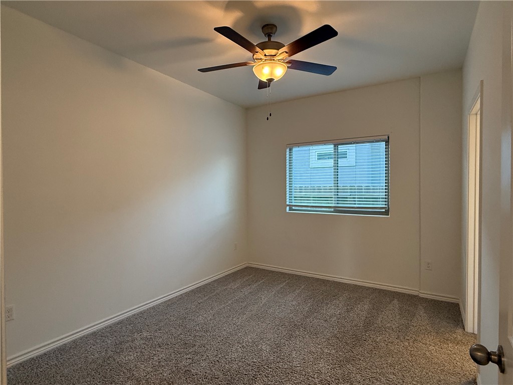7730 Hulk Drive Corpus Christi, TX 78414 - Photo 11 of 22 an empty room with a window and a ceiling fan