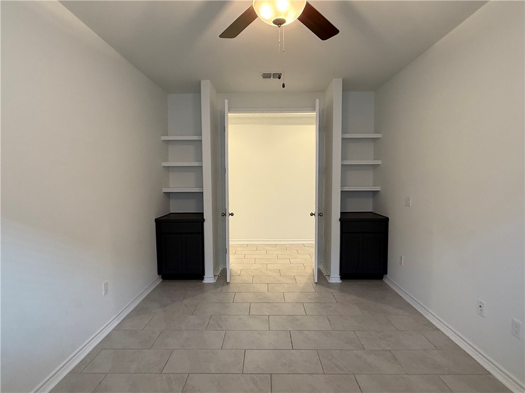 7730 Hulk Drive Corpus Christi, TX 78414 - Photo 13 of 22 an empty room with cabinet and windows