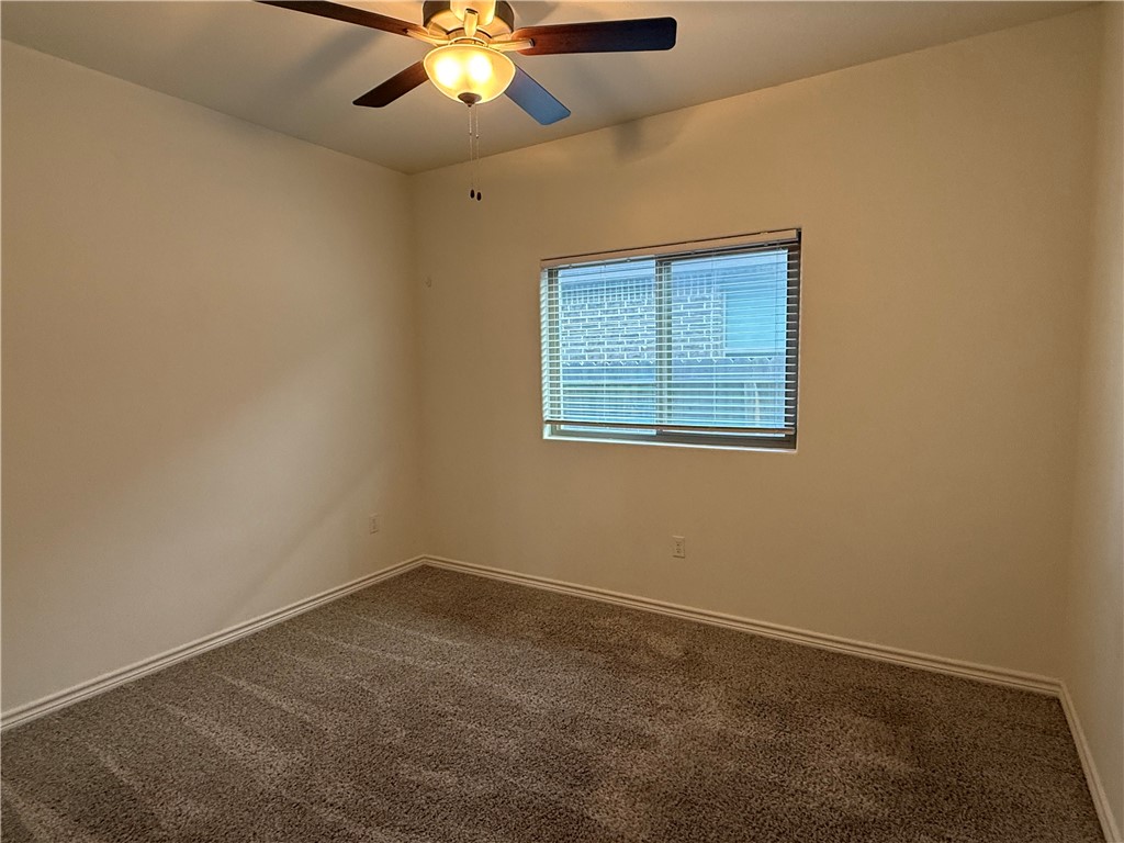 7730 Hulk Drive Corpus Christi, TX 78414 - Photo 14 of 22 an empty room with a window and a fan