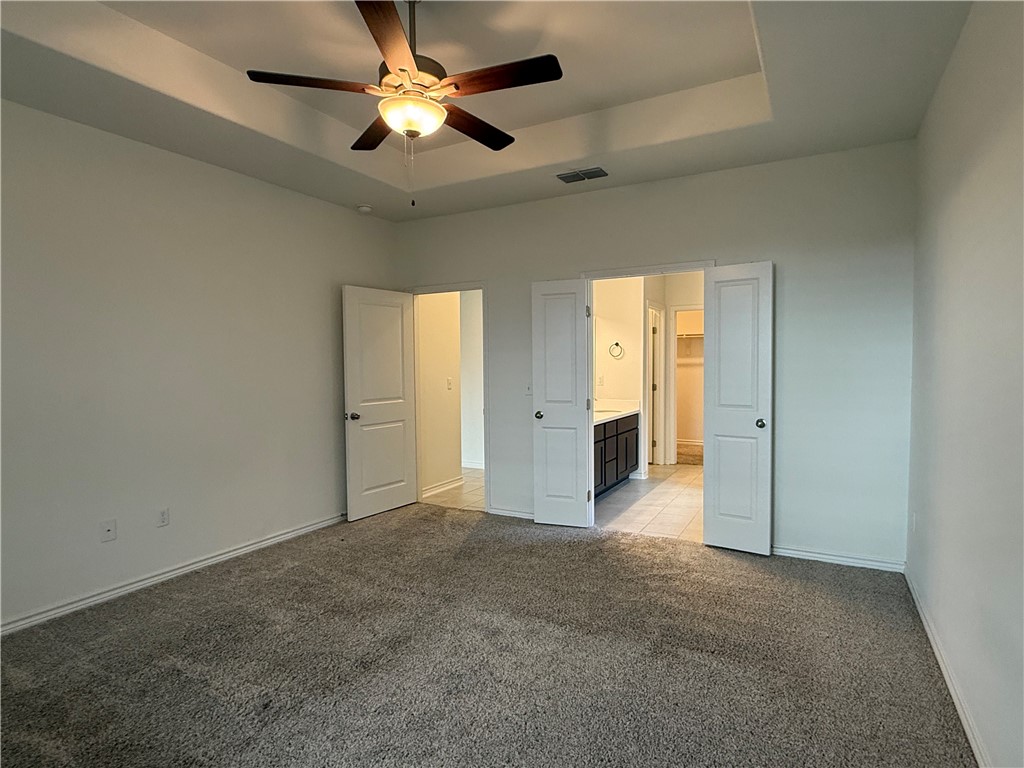 7730 Hulk Drive Corpus Christi, TX 78414 - Photo 17 of 22 an empty room with chandelier fan and closet area