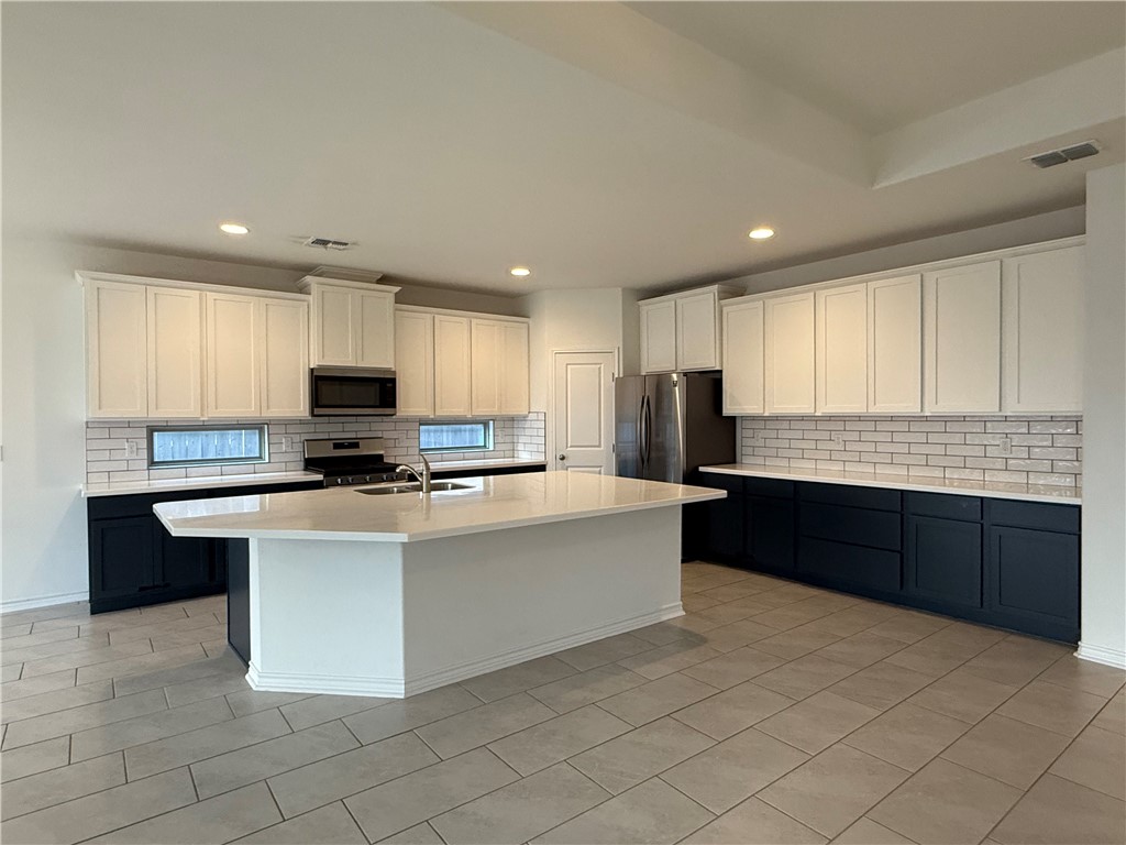 7730 Hulk Drive Corpus Christi, TX 78414 - Photo 7 of 22 a large kitchen with kitchen island granite countertop a stove top oven a sink dishwasher and a refrigerator