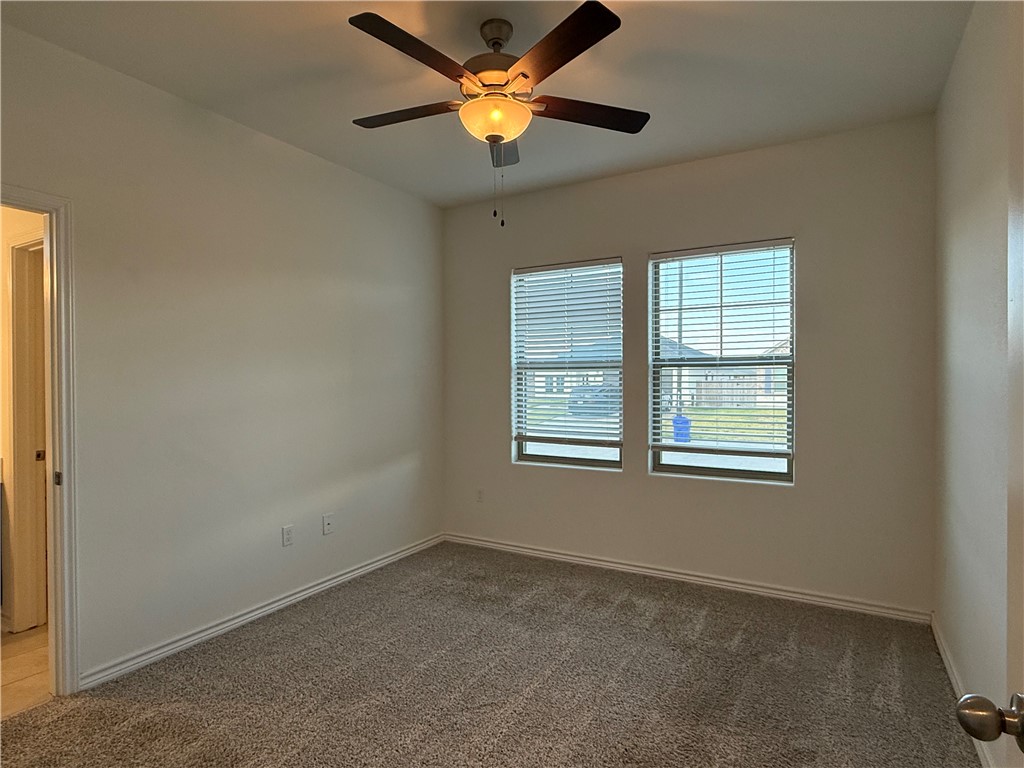 7730 Hulk Drive Corpus Christi, TX 78414 - Photo 8 of 22 an empty room with a window and a fan
