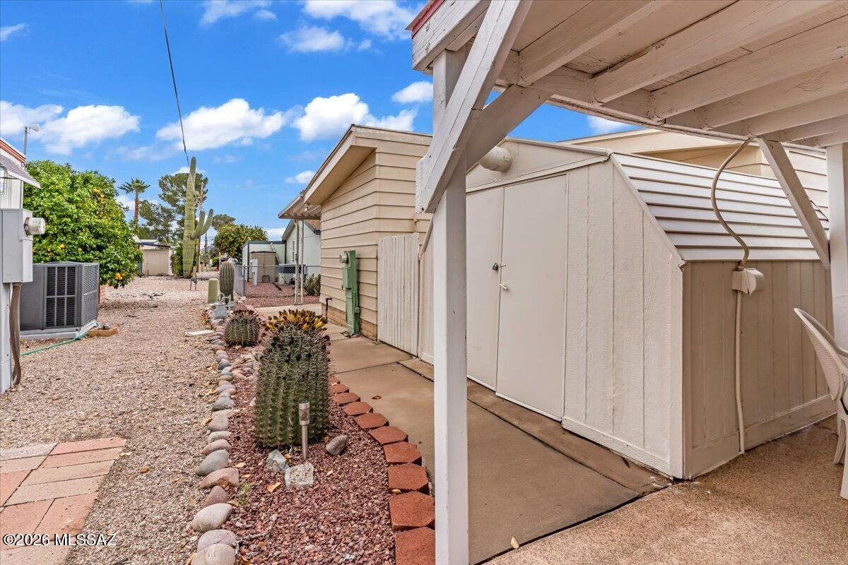 5840 West Flying W Street Tucson, AZ 85713 - Photo 35 of 38 a view of a porch with a table and chairs and floor to ceiling window and stairs