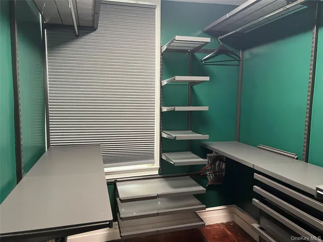 a view of a room with rack on the wall and a window