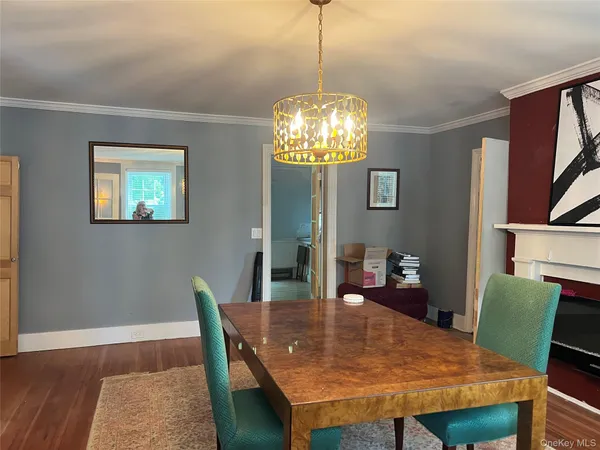 a view of a dining room with furniture and chandelier