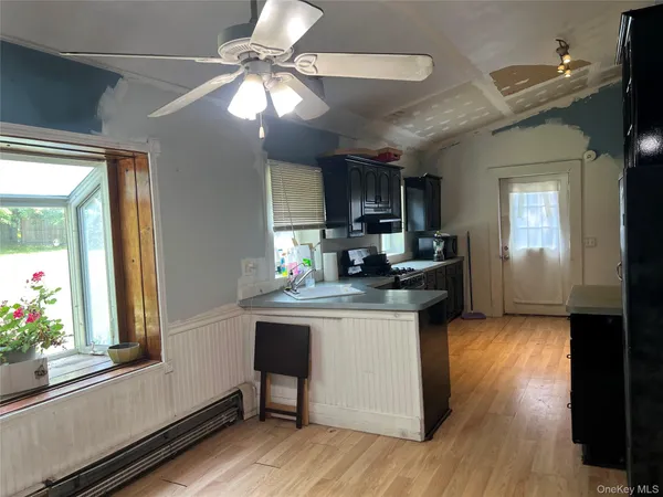a kitchen with granite countertop a stove a sink and a refrigerator