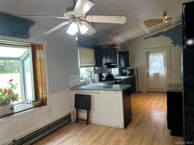 a kitchen with granite countertop a stove a sink and a refrigerator