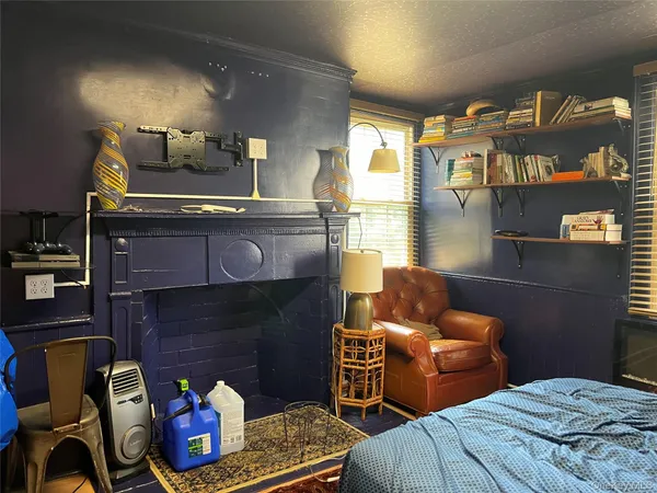 a bedroom with furniture and a fireplace