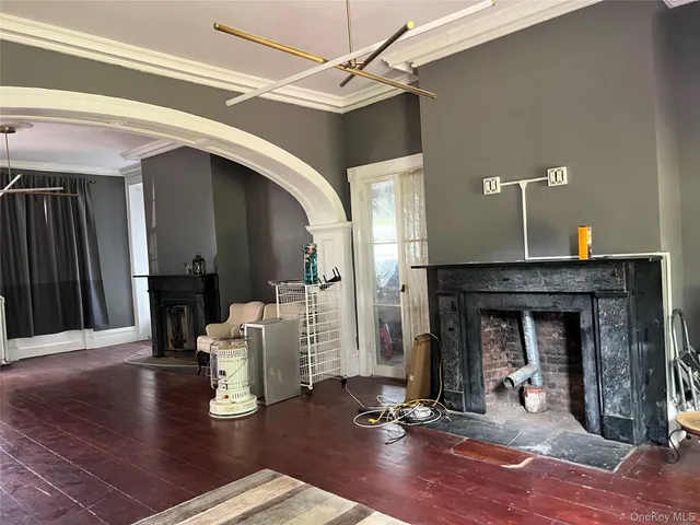 a living room with fireplace furniture and a wooden floor