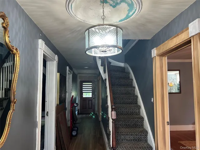 a view of a hallway with a chandelier