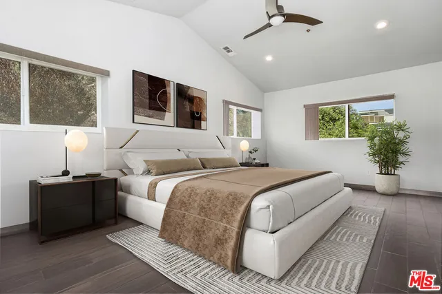 a bedroom with bed and a large window