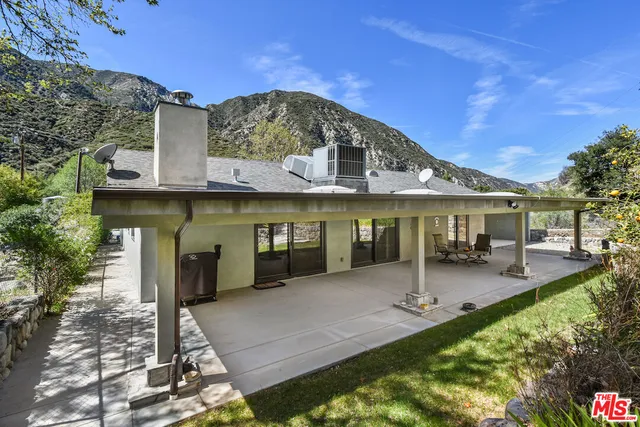a front view of a house with a garden and patio