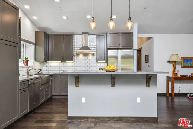 a kitchen with lots of counter space and appliances