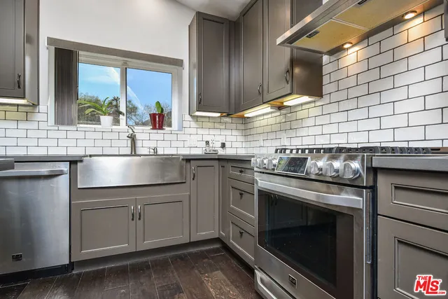a kitchen with a sink stove and cabinets