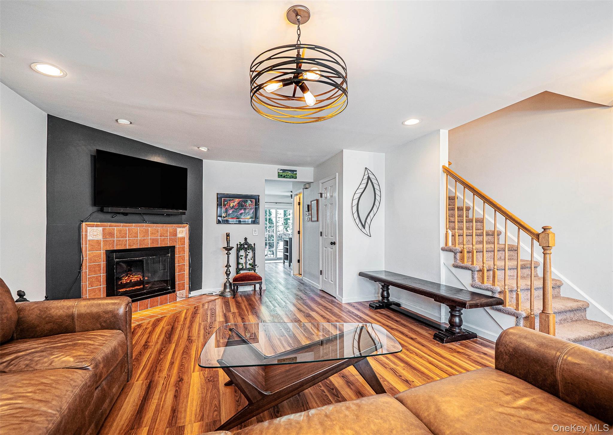 40 Weathervane Way Warwick, NY 10990 - Photo 5 of 29 a living room with furniture a fireplace and a flat screen tv