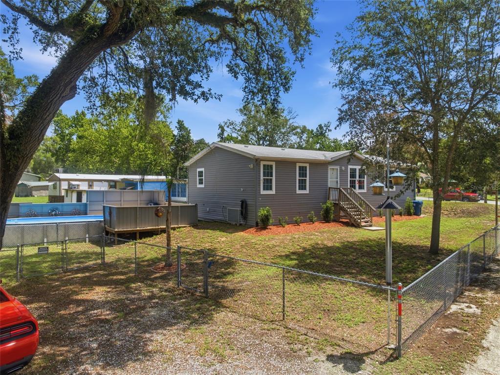 3183 Cedley Road Dade City, FL 33523 - Photo 28 of 48 a backyard of a house with table and chairs