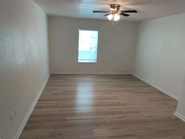 wooden floor in an empty room with a window