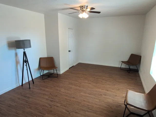 a workspace room with wooden floor and chair