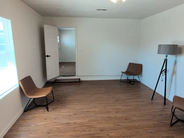 a room with a chair and a rug
