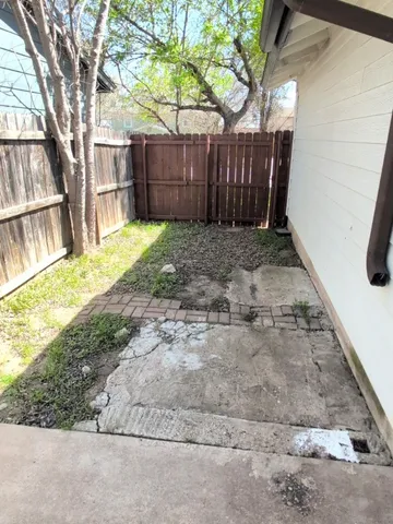 a view of a backyard with a small cabin and a chair