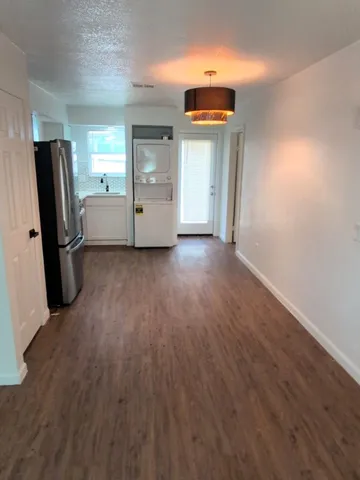 an empty room with closet and windows