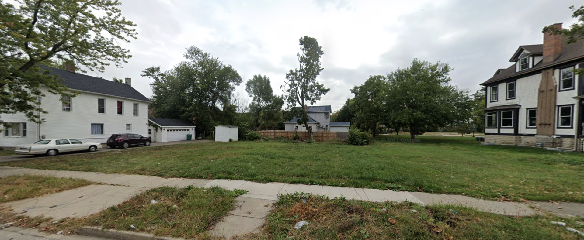 16 North Center Street Joliet, IL 60435 - Photo 3 of 3 a view of a white house in front of a big yard with plants and large trees
