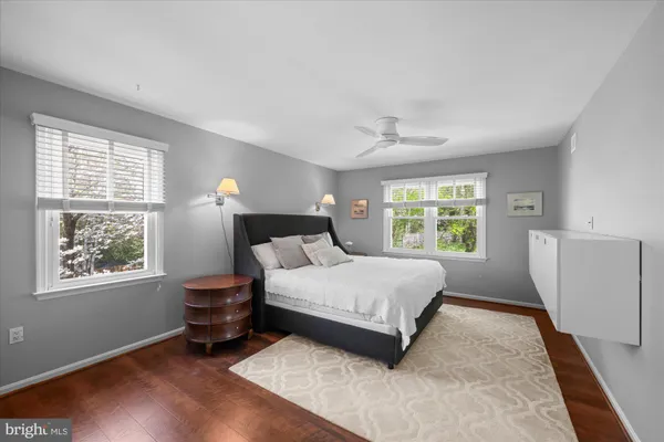 a bedroom with a bed dresser and a window