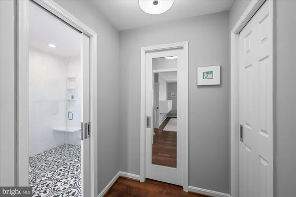 a bathroom with a double vanity sink a toilet and shower