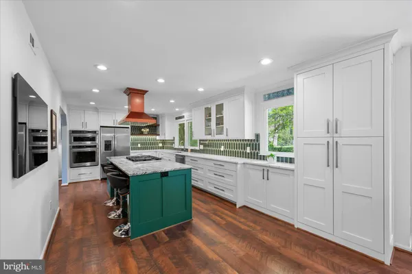 a kitchen with stainless steel appliances granite countertop a stove and a refrigerator