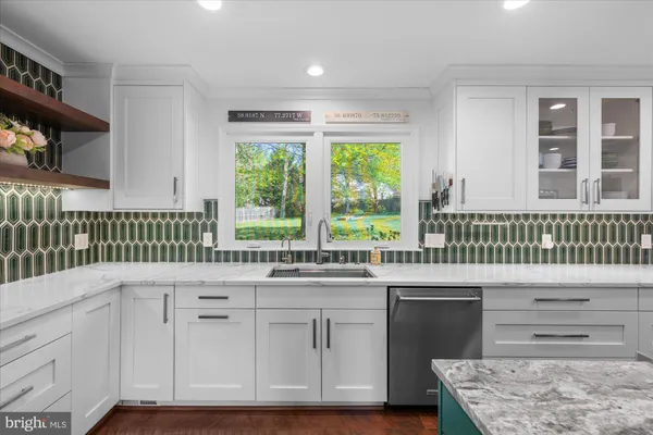 a kitchen with a sink window and cabinets