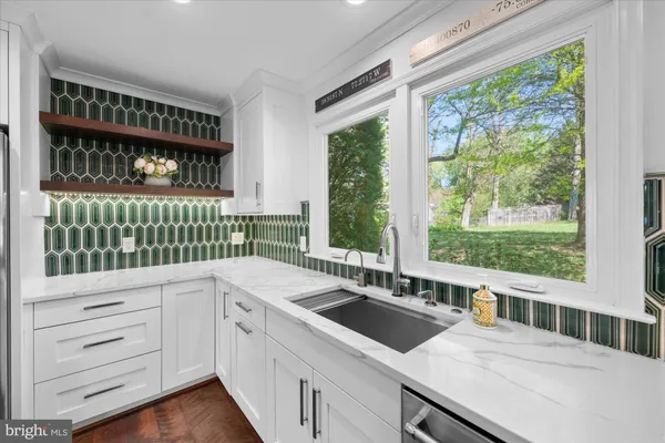 a kitchen with a sink and large window