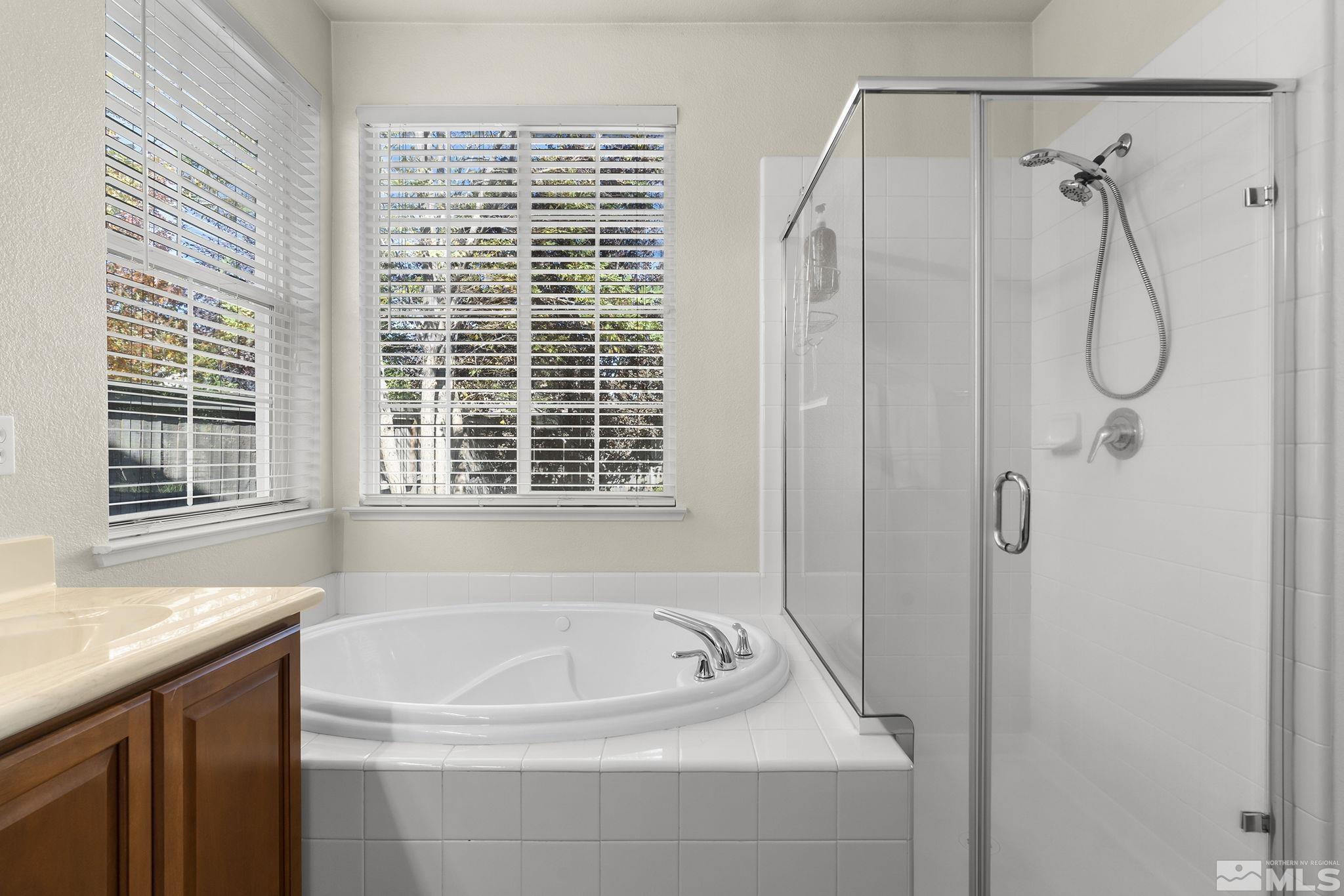 571 Needles Court Reno, NV 89521 - Photo 16 of 22 a bathroom with a bath tub and a window
