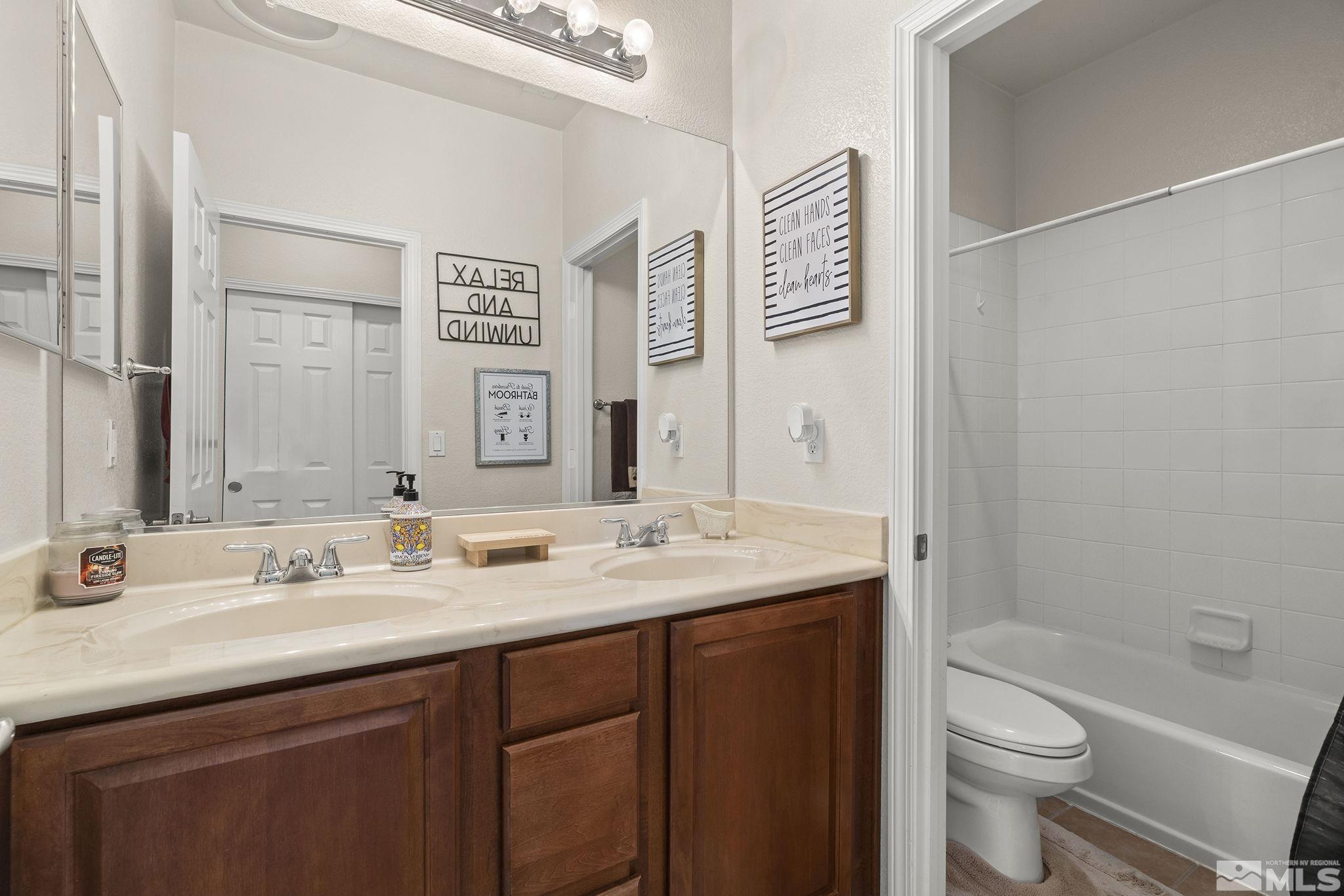 571 Needles Court Reno, NV 89521 - Photo 19 of 22 a bathroom with a granite countertop sink toilet and shower