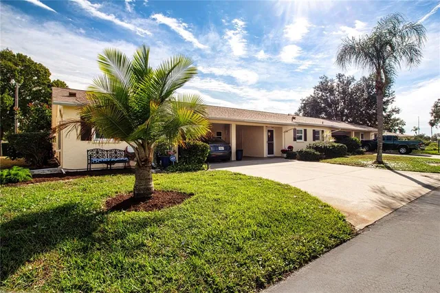 a house with green field in front of it