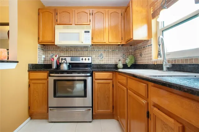 a kitchen with a refrigerator stove and oven