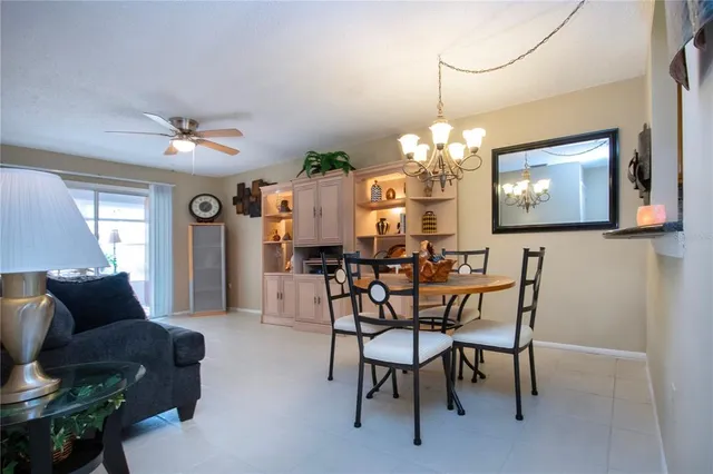 a living room with furniture a flat screen tv and a large window