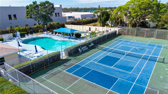 a room with pool table and windows