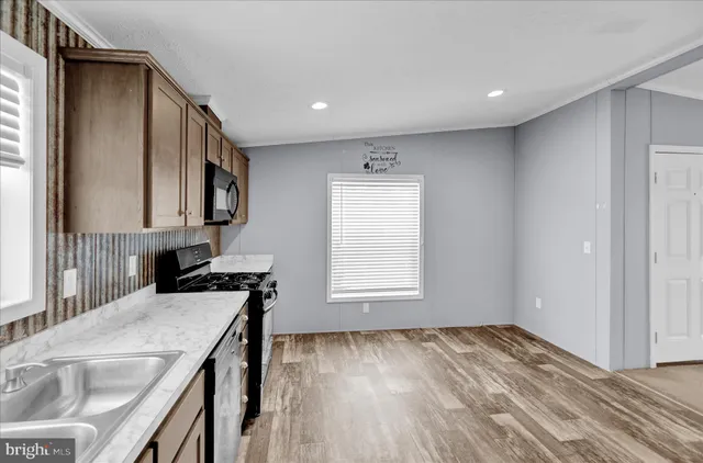 a view of a kitchen cabinets a sink and wooden floor