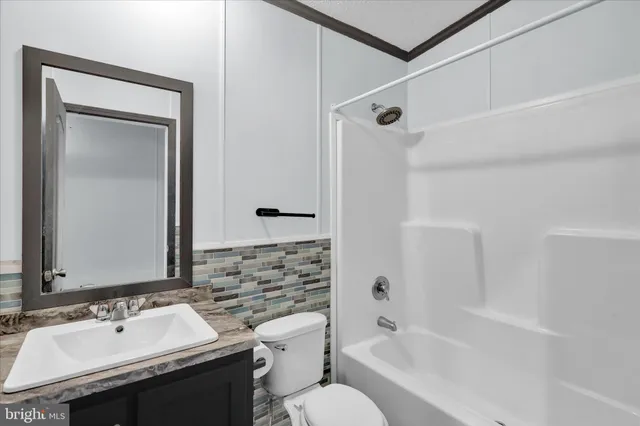 a bathroom with a sink toilet tub and shower